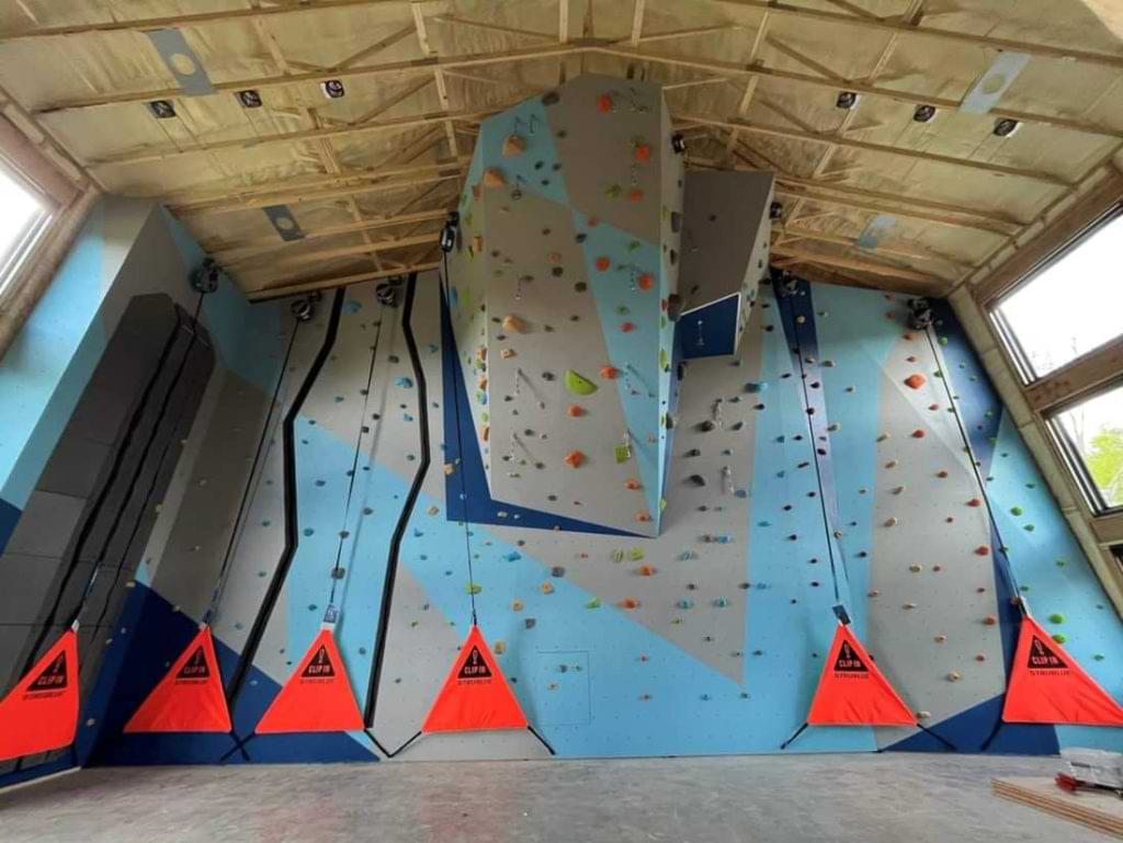 Campus rec center climbing wall with TRUBLUE auto belay devices and climbing system.